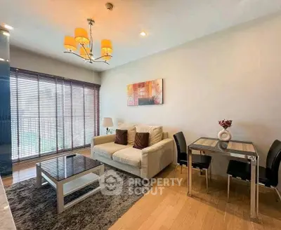 Modern living room with cozy sofa, stylish decor, and dining area in a bright apartment.