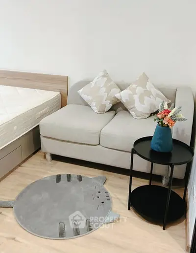 Cozy bedroom corner with stylish sofa and decorative accents