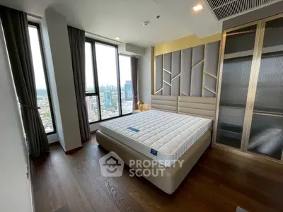Luxurious bedroom with stunning city view and modern design in high-rise apartment