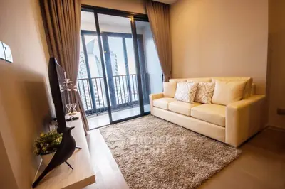 Modern living room with cozy sofa and city view balcony in high-rise apartment.