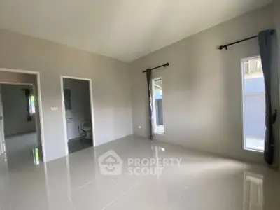 Spacious unfurnished room with large windows and tiled flooring