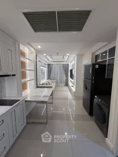 Modern open-layout living room with sleek kitchen and stylish decor