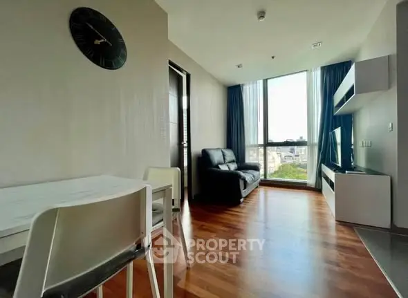 Modern living room with wooden flooring and large window view
