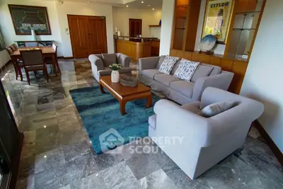 Spacious living room with elegant furniture and marble flooring in a modern home.