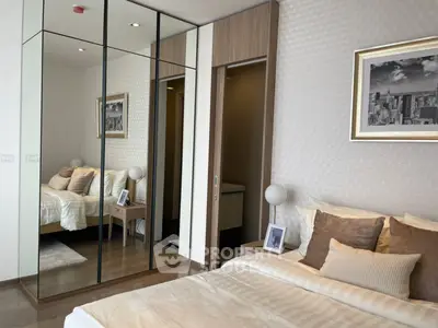 Luxurious bedroom with mirrored closet and elegant decor in modern apartment