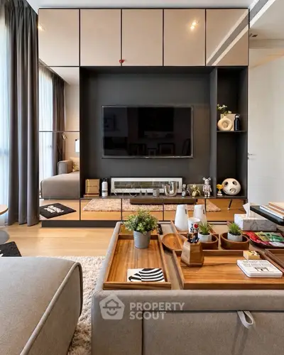 Modern living room with stylish decor and built-in entertainment center.