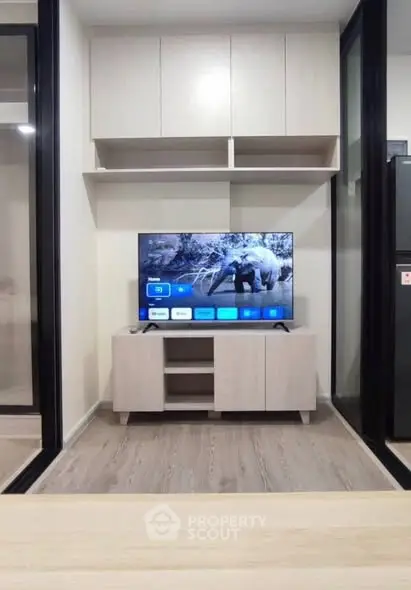 Modern living room with sleek TV setup and stylish cabinetry