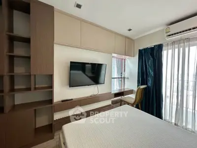 Modern bedroom with built-in shelves, wall-mounted TV, and large window with city view.