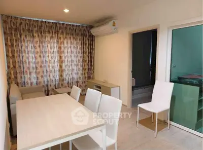 Modern living room with dining area and air conditioning in a cozy apartment.