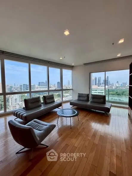 Spacious living room with panoramic city views and modern furniture