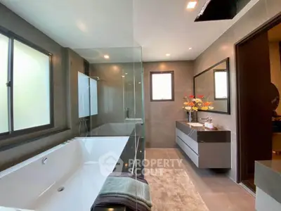 Luxurious modern bathroom with sleek design and large bathtub, perfect for relaxation.