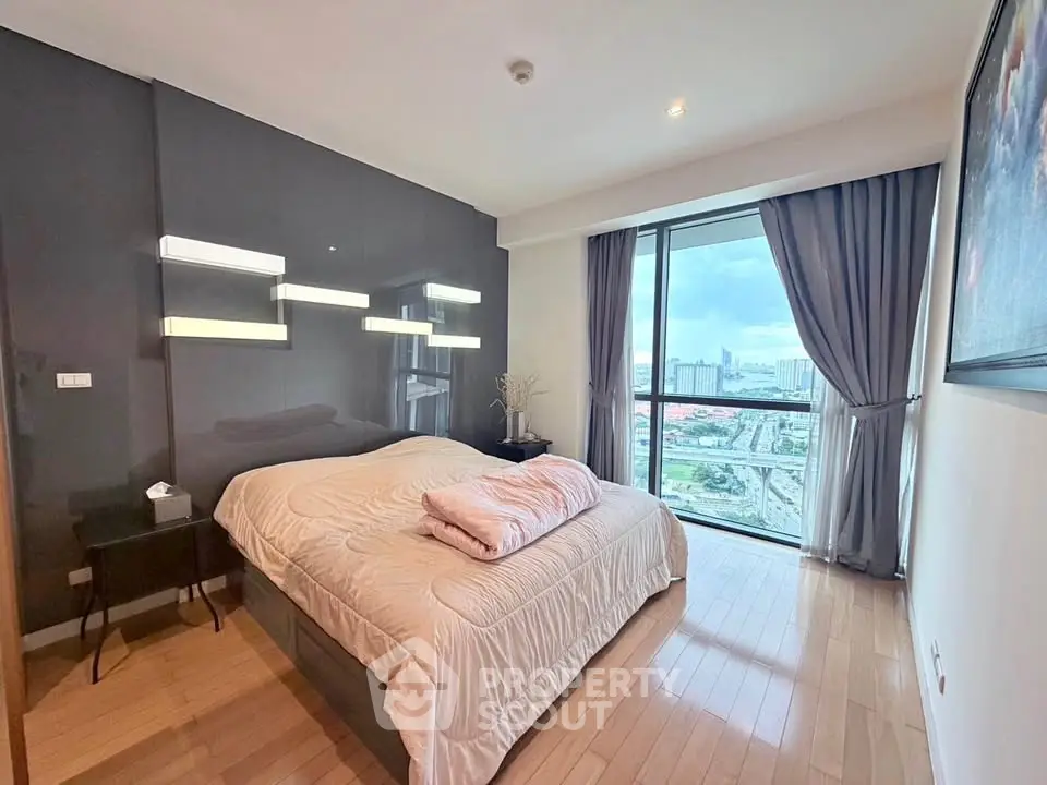 Luxurious bedroom with city view and modern decor in high-rise apartment