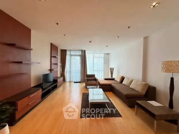 Spacious modern living room with sleek furniture and natural light.