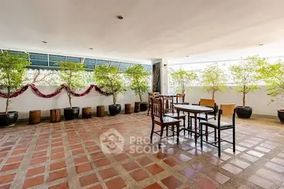 Spacious terrace with potted plants and seating area, perfect for relaxation.