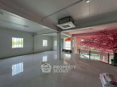 Spacious modern interior with glossy floors and vibrant decor, ideal for creative living spaces.