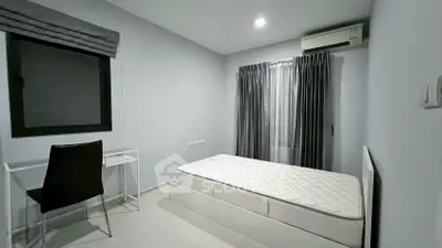 Modern minimalist bedroom with single bed and study desk, featuring sleek design and ample natural light.