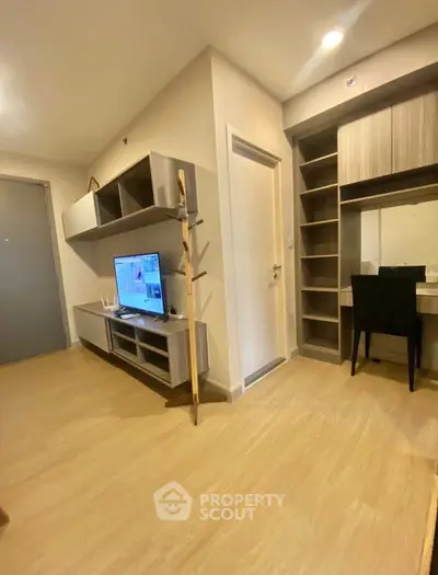 Modern living room with stylish furniture and built-in shelving, perfect for urban living.