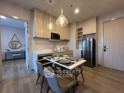 Modern kitchen with dining area and stylish decor in a cozy apartment setting.