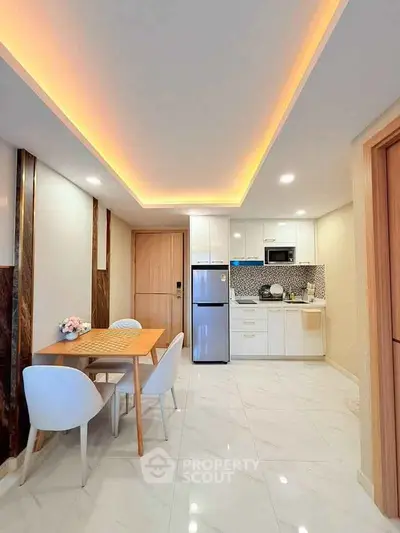 Modern kitchen with sleek design, open layout, and stylish dining area in a contemporary apartment.