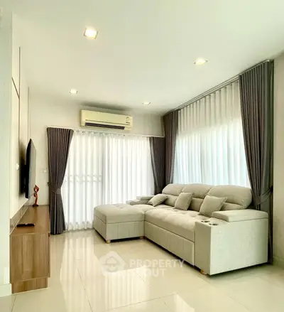 Modern living room with cozy sectional sofa and natural light