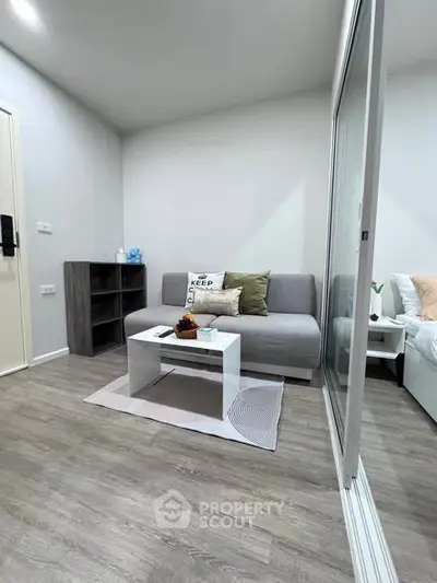 Modern living room with sleek design and cozy ambiance, featuring a stylish sofa and coffee table.