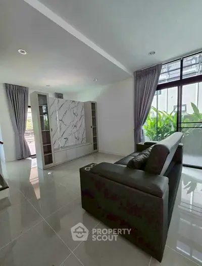 Modern living room with sleek marble feature wall and large windows