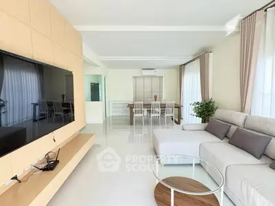 Spacious modern living room with sleek furniture and large windows for natural light.