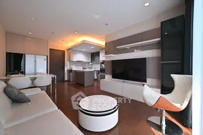 Modern living room with sleek furniture and open kitchen layout