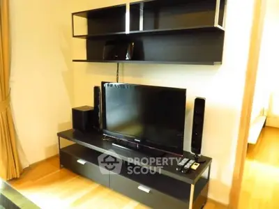 Modern living room with sleek entertainment center and flat-screen TV.