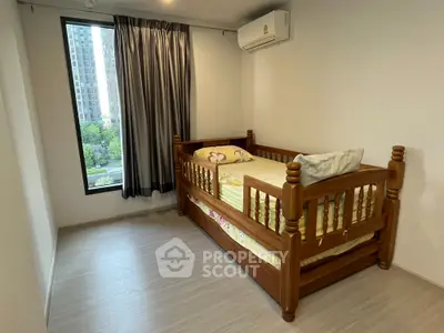 Cozy bedroom with wooden bed and large window offering city view