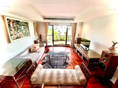 Spacious living room with modern decor and large window view in luxury apartment