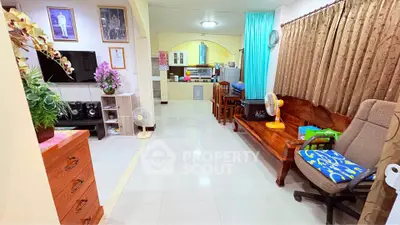 Spacious living room with modern decor and open kitchen layout