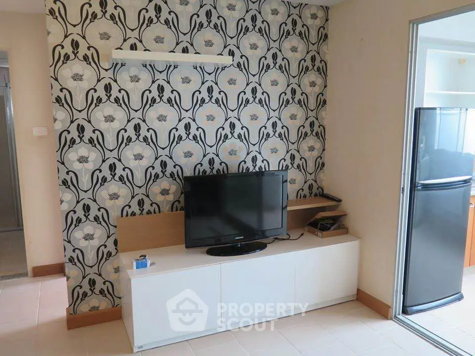Stylish living room with modern TV setup and elegant wallpaper design