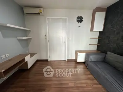 Modern living room with sleek shelves and stylish sofa, featuring a minimalist design and wooden flooring.