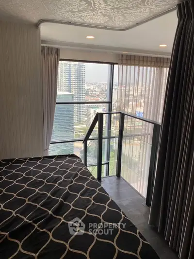 Modern bedroom with floor-to-ceiling windows offering stunning city views, elegant decor, and ample natural light.