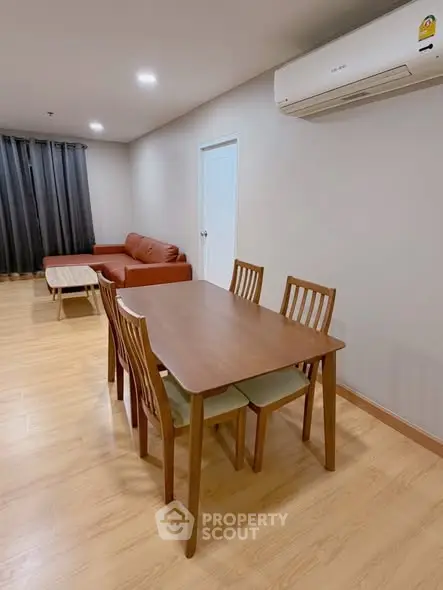 Spacious living room with modern furniture and air conditioning, perfect for comfortable living.