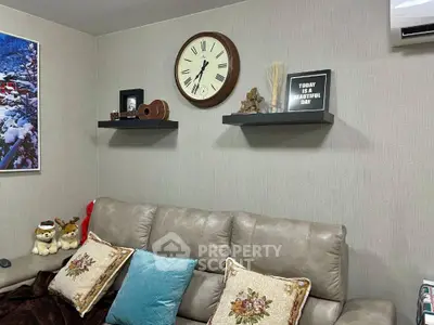 Cozy living room with decorative shelves and plush sofa, perfect for relaxation.