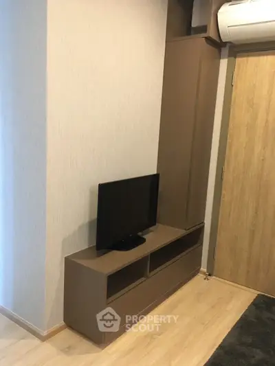 Modern living room corner with sleek TV stand and air conditioning unit