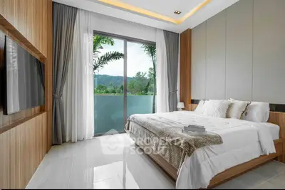 Luxurious bedroom with large window and scenic view, featuring modern decor and cozy bedding.