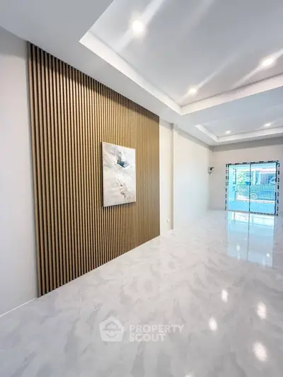 Spacious modern living room with elegant wood paneling and glossy tile flooring