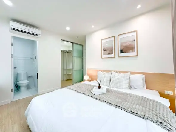 Modern bedroom with ensuite bathroom, featuring cozy decor and soft lighting for a relaxing ambiance.