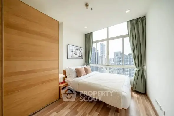 Bright modern bedroom with city view and wooden flooring