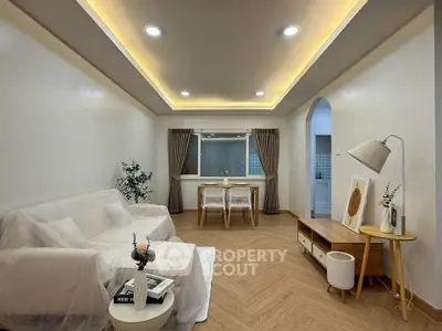 Modern living room with cozy seating and elegant lighting