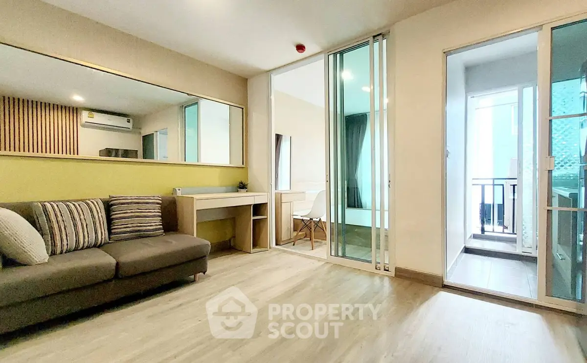 Modern living room with stylish decor and balcony access in a contemporary apartment.