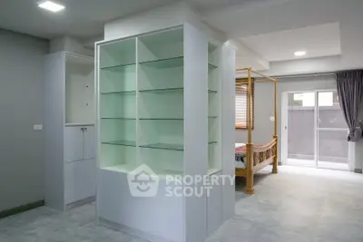 Spacious modern interior with built-in shelving and natural light, ideal for stylish living.