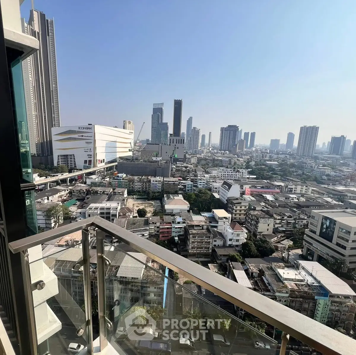 Stunning cityscape view from a high-rise balcony with modern skyline and urban landscape.