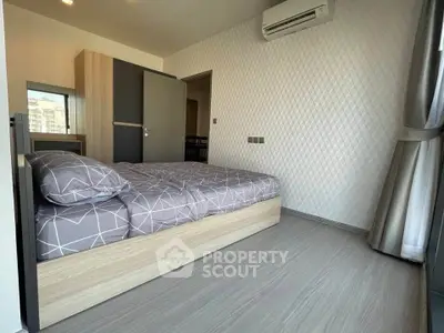 Modern bedroom with stylish decor and air conditioning in a contemporary apartment.