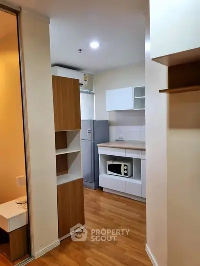 Modern compact kitchen with wooden flooring and built-in microwave
