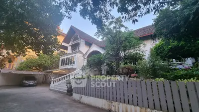 Charming colonial-style house with lush garden and spacious driveway