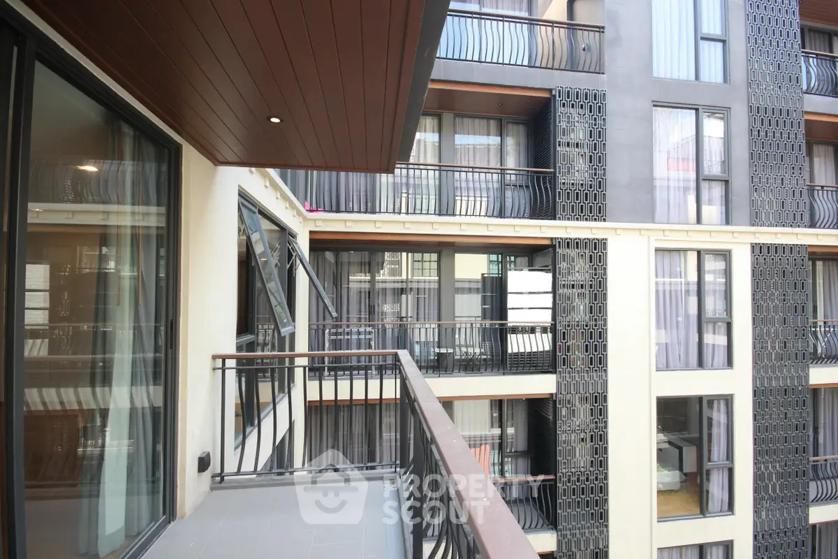Modern apartment building with stylish balconies and large windows, offering a contemporary urban living experience.